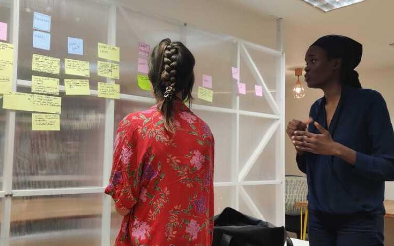 Living proof staff talking in front of planning board